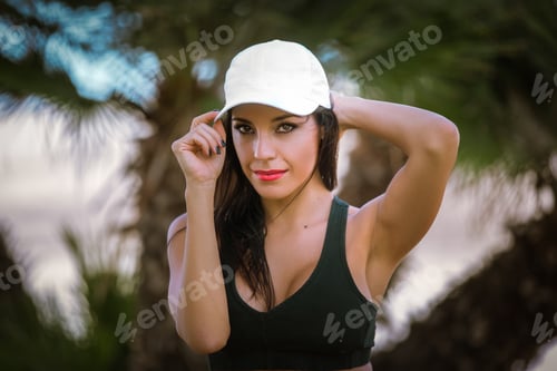 Preview: Athlete woman between palm trees on the beach