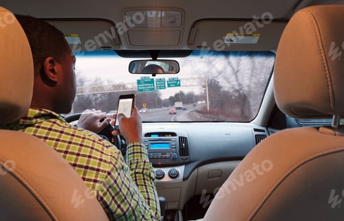 Preview: Are African-American man on cell phone while driving down Highway