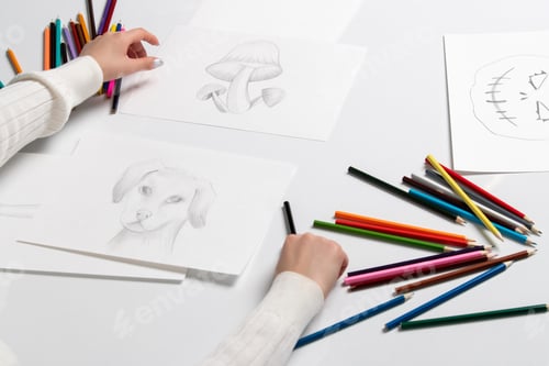 Preview: Drawing a young girl hand on the drawings of bunny mushrooms and halloween pumpkin