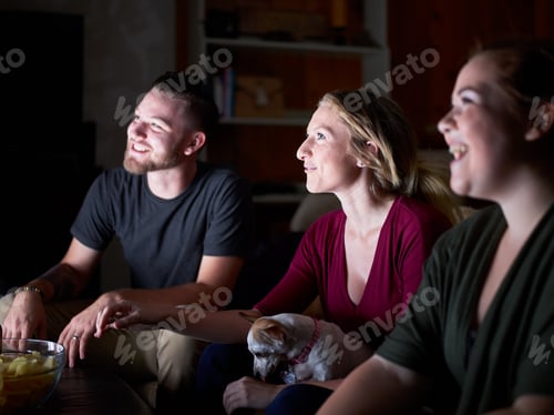 Preview: Happy Friends Watching TV With Dog At Home