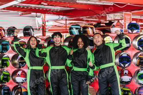 Preview: Friends celebrating go kart racing victory indoors