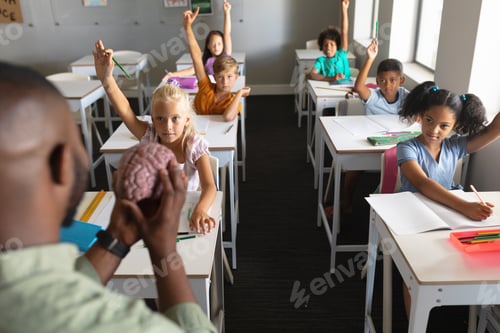 Preview: Enthusiastic Students Raising Hands in Classroom