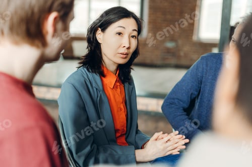 Preview: Asian businesswoman leading meeting with her team in office