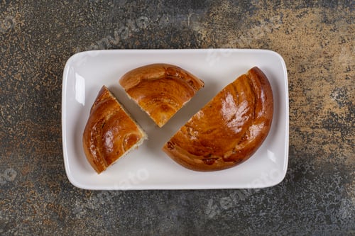 Preview: Sliced fresh pastry on white square plate