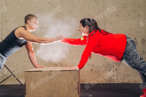 Preview: laughing man and woman doing exercises on the box