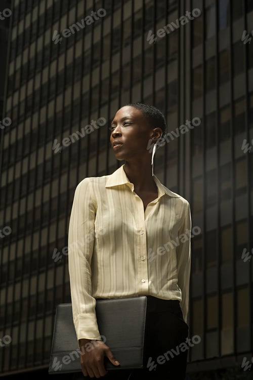 Preview: Confident professional woman standing tall in an urban setting