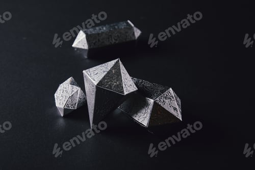 Preview: high angle view of shiny faceted silver pieces on black