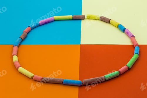 Preview: colored crayons on a background of different paper
