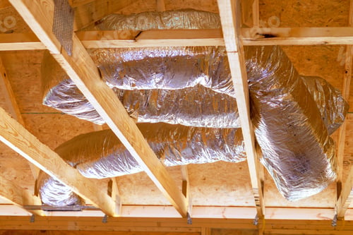 Preview: Installing ventilation HVAC pipes with silver insulation on roof a ceiling during construction