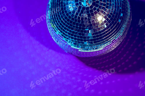 Preview: disco ball shines on purple background close up