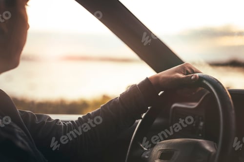 Preview: Sunset road trip vibes as a person drives towards the horizon