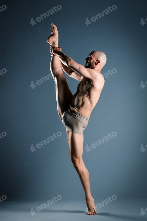 Preview: Shirtless male dancer performing split in studio