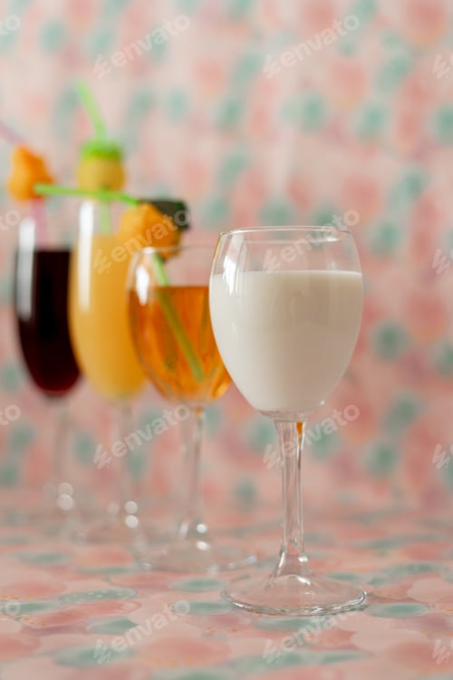 Preview: Delicious colorful healthy drinks for children and adults in wine glasses.