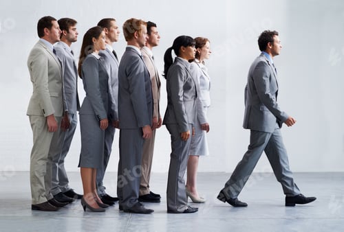 Preview: Leading by example. A young business manager walking ahead of his colleagues - Leadership.