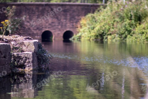 Preview: A canal in the UK with brick wall