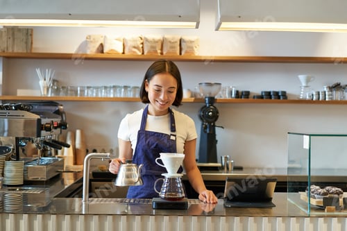 Preview: Smiling asian girl barista, working in cafe, brewing coffee v60, preparing order behind counter