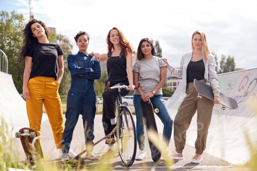 Preview: Portrait Of Female Friends With Skateboards And Bike In Urban Skate Park