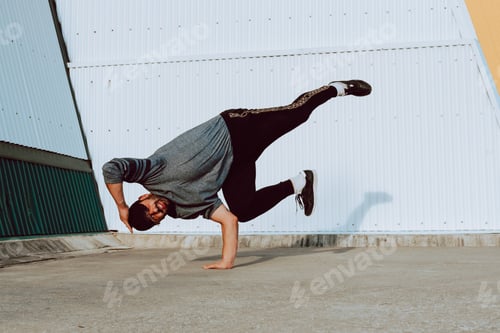 Preview: Man performing handstand near wall