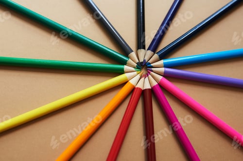 Preview: Studio shot of different coloured pencils against a brown background
