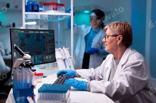 Preview: Senior scientist researcher engineering vaccine with team in pharmacology chemical facility