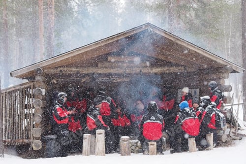 Preview: Number of sportsmen sitting under a wooden roof in winter