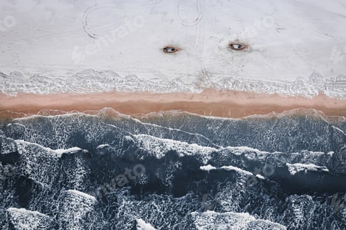 Preview: Fishing boats on snowy beach at winter Baltic Sea.