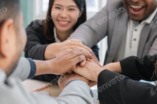 Preview: Diverse colleagues business team joining hands together, showing company staff unity, celebrating