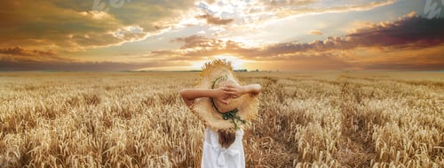 Preview: A child in a wheat field. Selective focus.