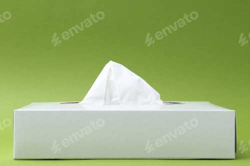 Preview: Box with paper handkerchiefs on green background. Space for text