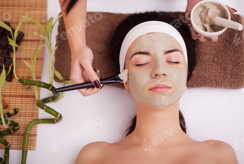 Preview: Applying facial mask at woman face at beauty salon