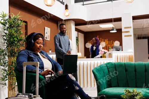 Preview: Woman working online in hotel lobby