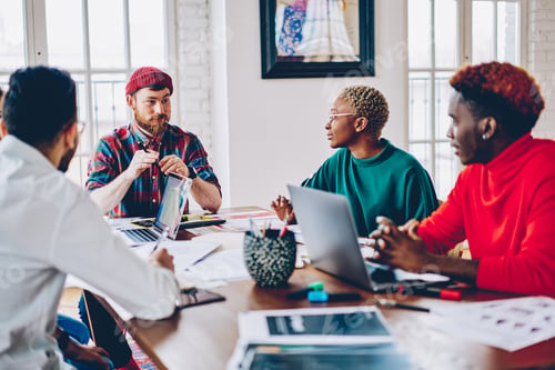 Preview: Skilled hipsters with laptop communicate about business project