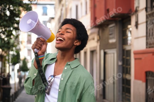 Preview: Young activist shouting with megaphone during LGBT pride parade