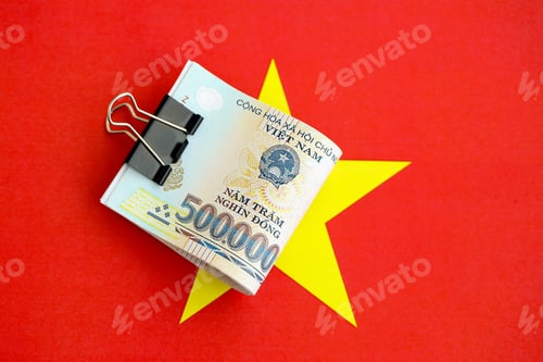 Preview: Vietnamese dong currency money bills lies on flag. The concept of business and investment