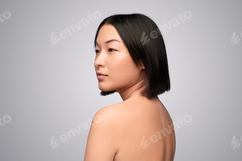 Preview: Young Asian woman with naked back looking away