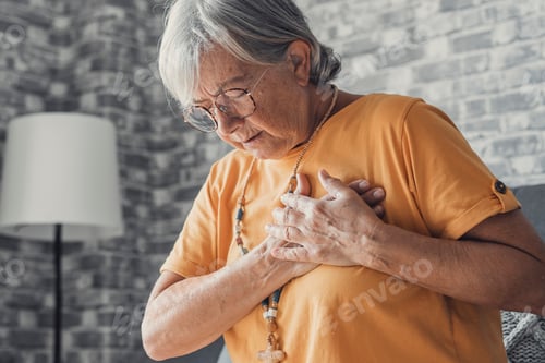 Preview: Upset stressed mature middle aged woman feeling pain ache touching chest having heart attack