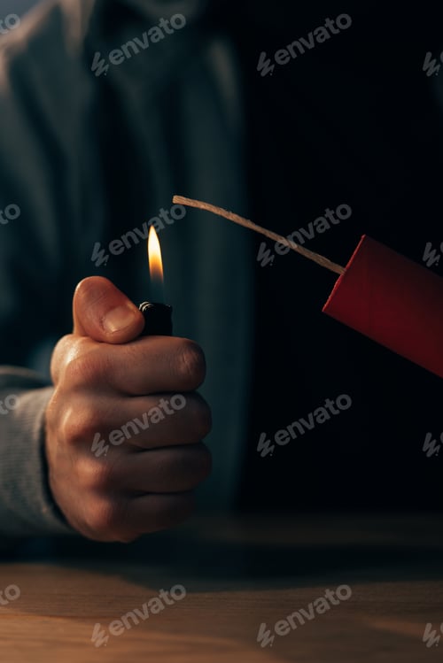 Preview: Partial view of man holding lighter and igniting dynamite