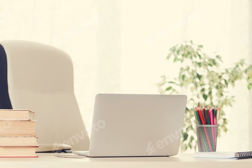 Preview: Home office workplace with laptop and supplies