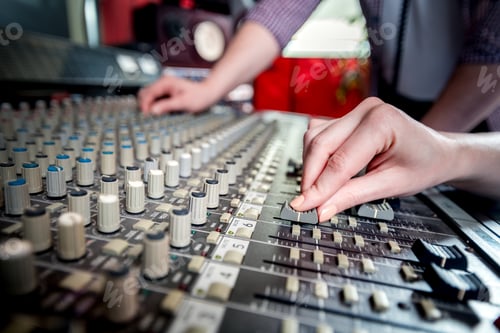 Preview: Music engineers working together in recording studio using mixing desk
