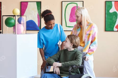 Preview: Group of friends with teenager in wheelchair visiting art gallery