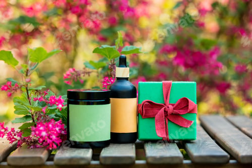Preview: Cosmetic bottle and gift box on wooden table in spring time blooming garden