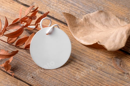 Preview: Round white tag mockup on a rustic wooden background with cotton string and boho decoration