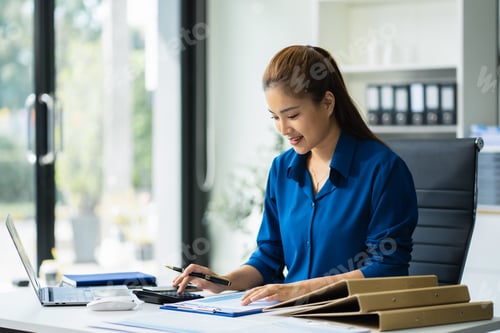 Preview: Business woman doing finances and calculate on desk about cost at office.