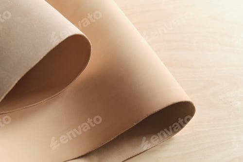 Preview: collection of high-quality beige leather swatches in various shades, showcasing their natural
