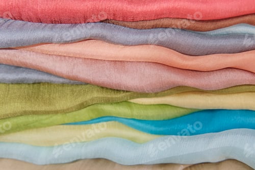 Preview: Colorful Silk Fabric in Stacked Layers Close-Up