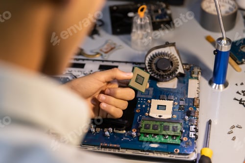 Preview: Computer repair technician repairing a laptop