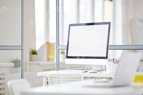 Blank Computer Screen in Modern Glass Office Interior