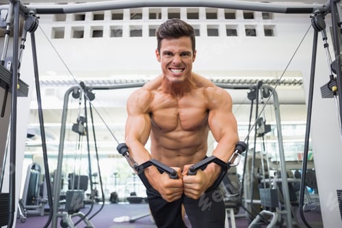 Preview: Portrait Of A Shirtless Young Muscular Man Using Resistance Band In Gym
