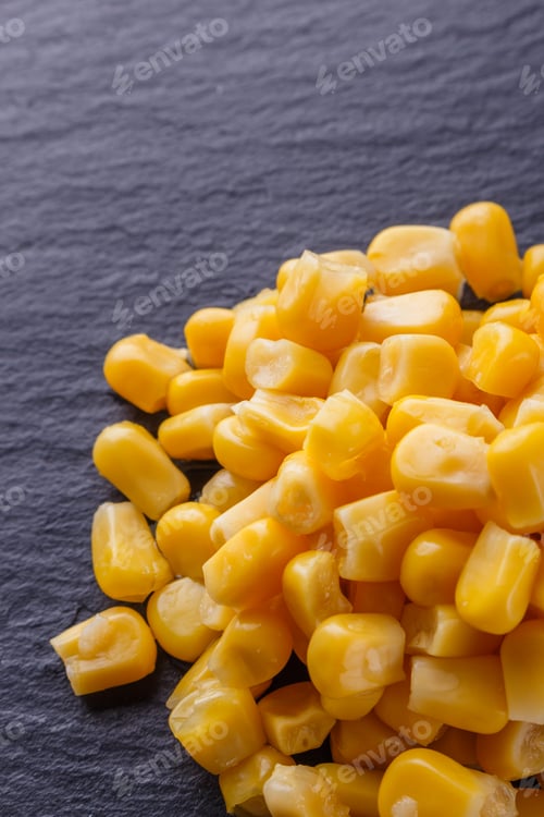 Preview: canned corn on a dark stone background