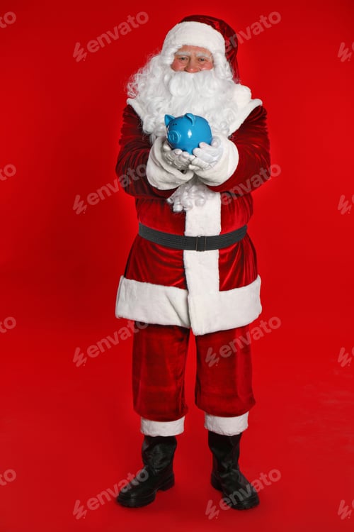 Preview: Santa Claus holding piggy bank on red background